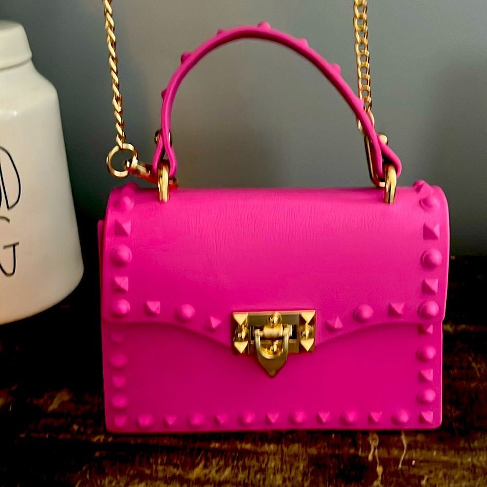 Pink purse with studded details, gold accents. Cross body or clutch.